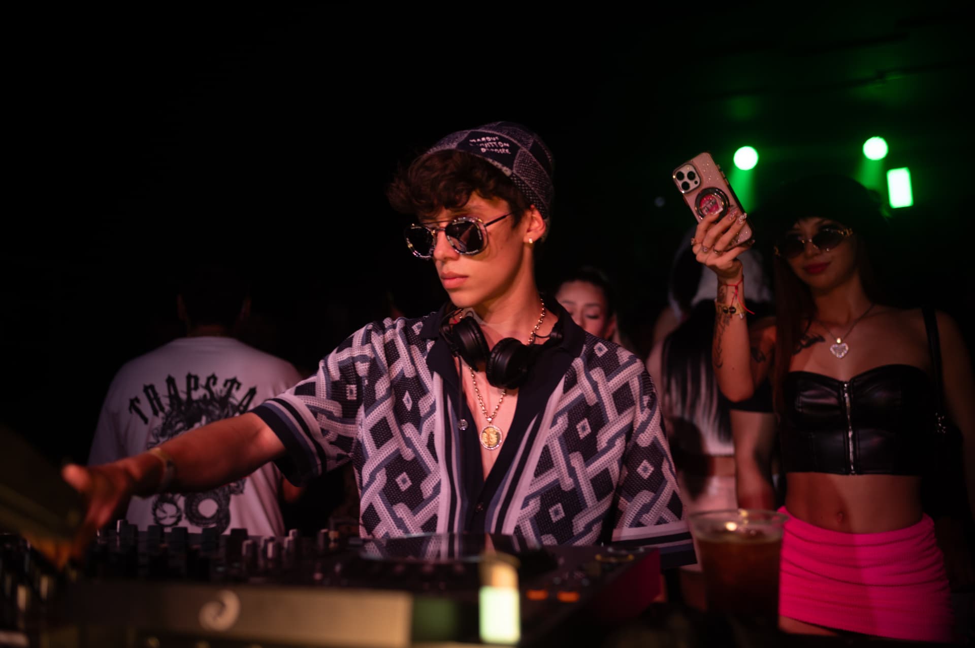 JACÓSTA reaching across the mixer with the crowd behind